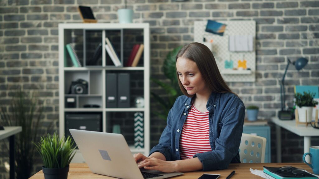 woman sitting at computer investing